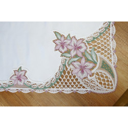 Nahaufnahme von floraler Plauener Spitze mit fliederfarbener Lilien-Stickerei für elegante Tischdeko.