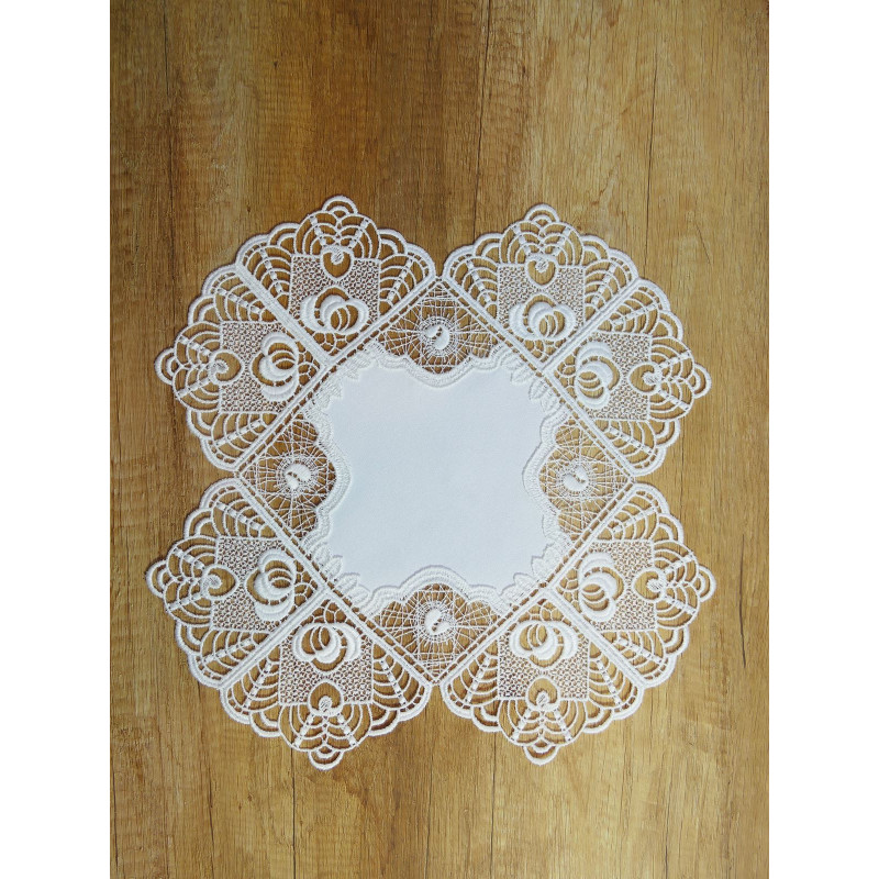 Quadratisches Tischset aus Plauener Spitze mit Fantasie-Muster für edle Heimtextilien im Landhausstil auf Holz.