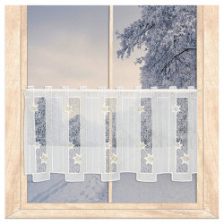 Halbtransparente Scheibengardine aus Plauener Spitze mit goldenen Sternen am verschneiten Fenster im Winter.