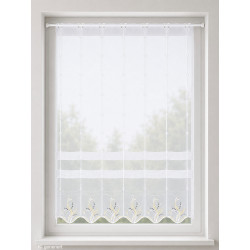 Halbtransparente Kurzgardine mit floraler Stickerei in Gelb und Anthrazit vor hellem Fensterhintergrund im Landhausstil.