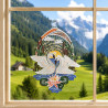 Gesticktes Fensterbild mit zwei Schwänen auf einem See im romantischen Frühlings-Ambiente am Fenster.