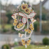 Zartes Plauener Spitze Fensterbild mit gelbem Zitronenfalter vor einem hellen Fenster mit frühlingshaftem Garten-Ausblick.
